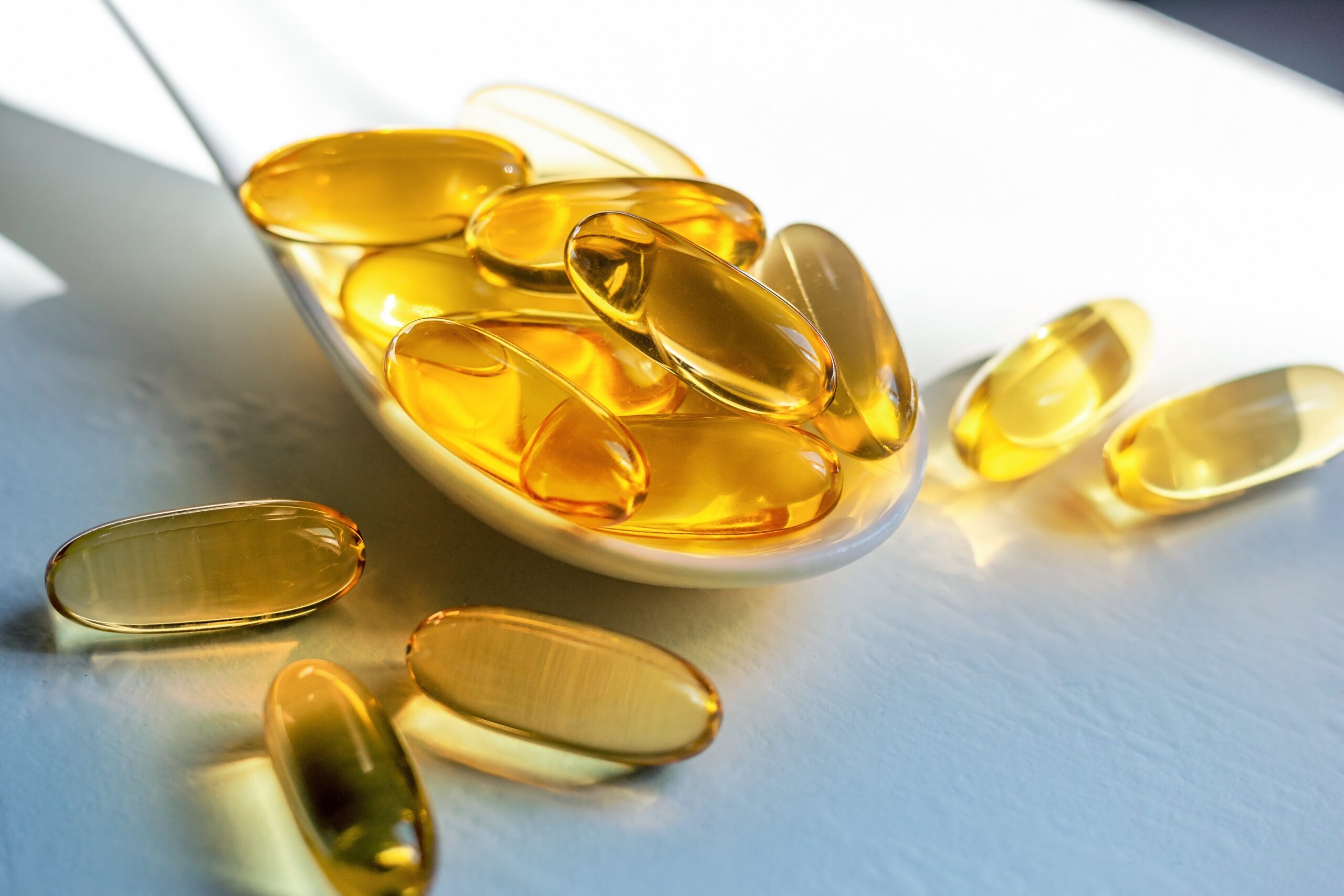 Main - Kesihatan D'Aura D'Aura spoon with capsules fish oil omega 3 fatty acids close up min scaled