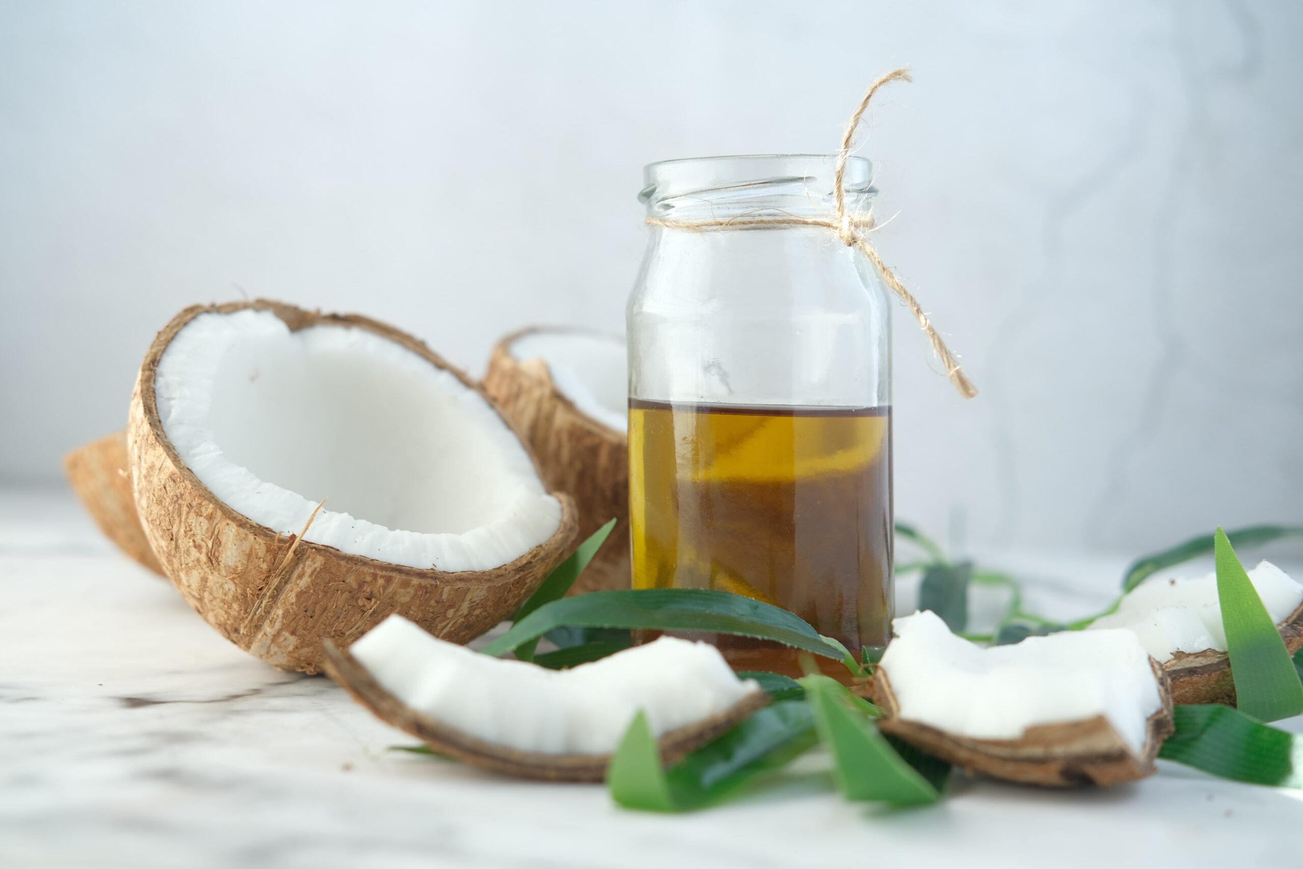 slice-of-fresh-coconut-and-bottle-of-oil-on-a-tabl-2023-02-03-01-58-03-utc-min D'Aura slice of fresh coconut and bottle of oil on a tabl 2023 02 03 01 58 03 utc min scaled